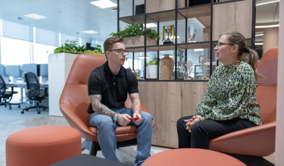 Two people sitting on an office