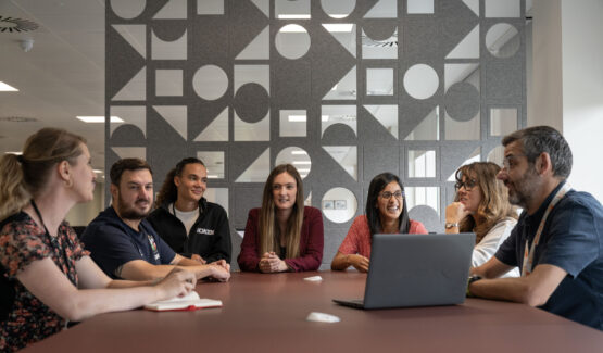 Group of people sitting round a table